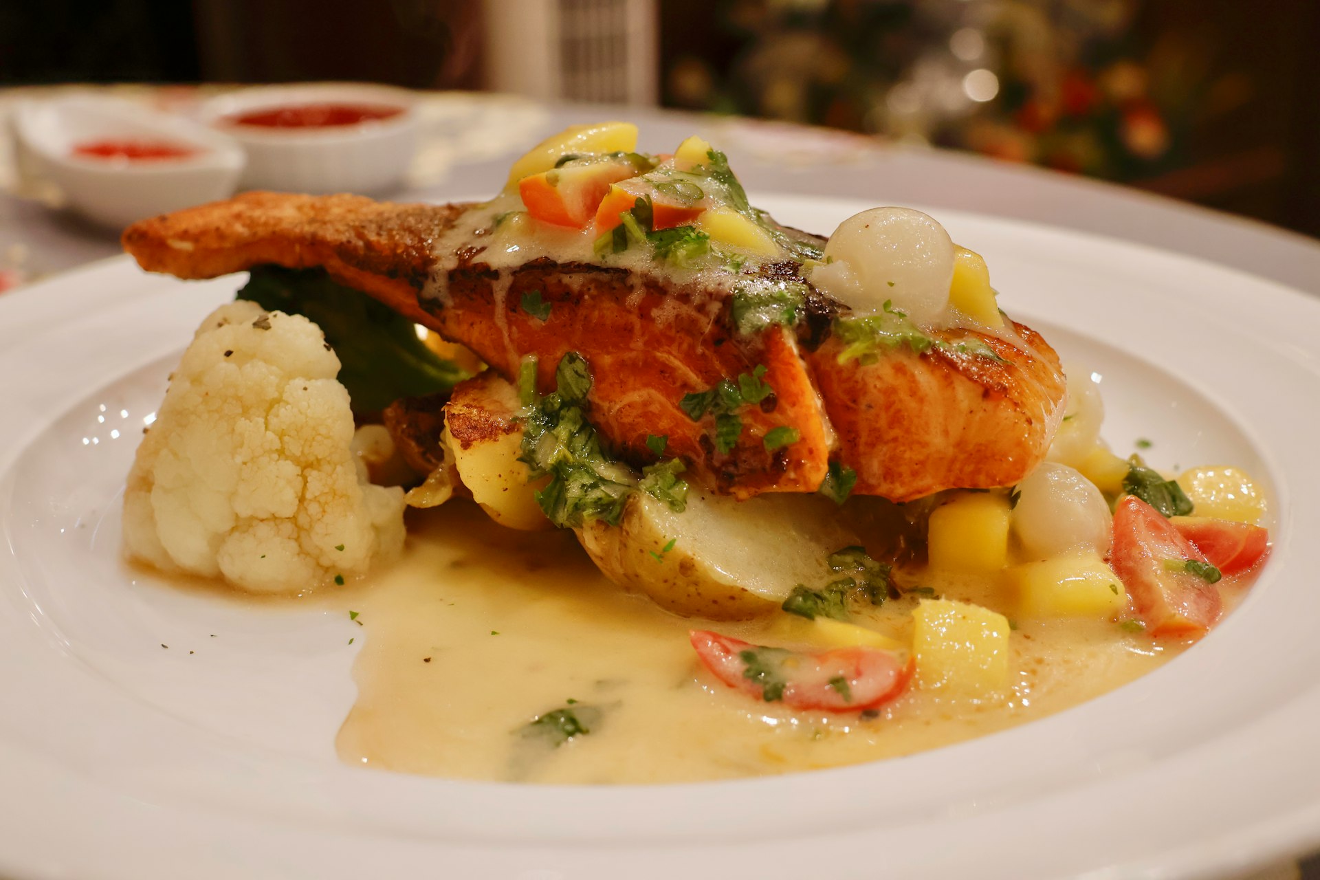 a white plate topped with fish and vegetables